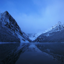 SNOW ON LAKE LOUISE AT NIGHT, VERY EARLY MORNING SUNRISE WITH TH